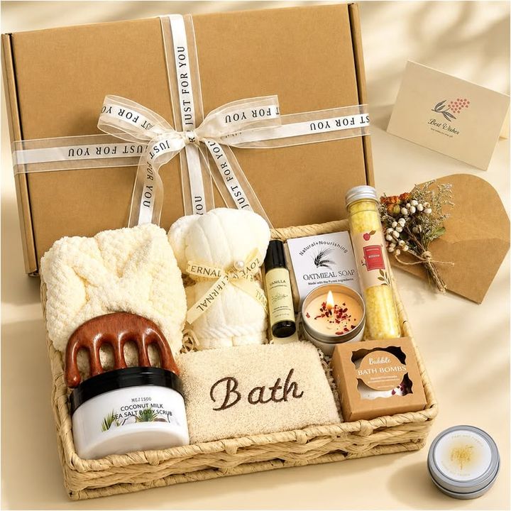 A gift basket with towels, scrub, candle and bath treats